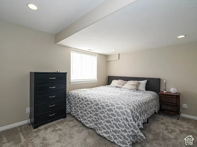 Recessed lighting, neutral wall tones, window with white blinds, and carpeted flooring