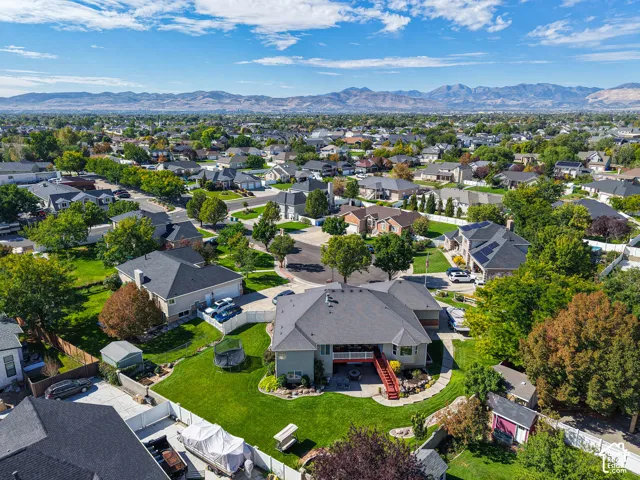 Spacious residential neighborhood with mature trees, offering mountain scenery in the background