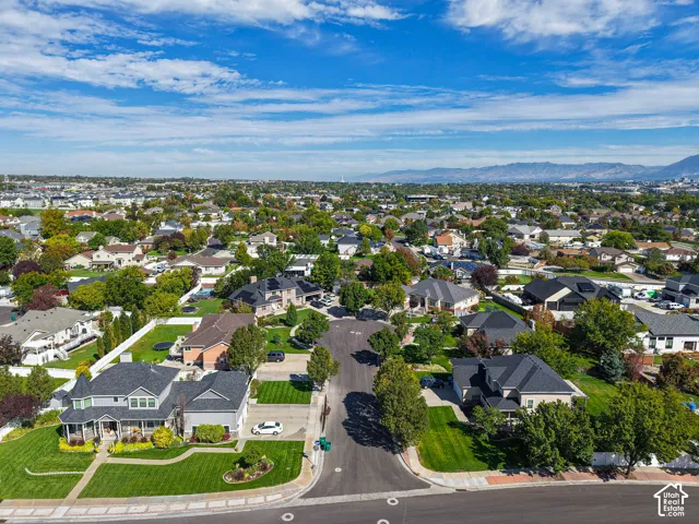 Established residential community featuring mature trees, consistent lot sizes, and mountainous terrain in the distance