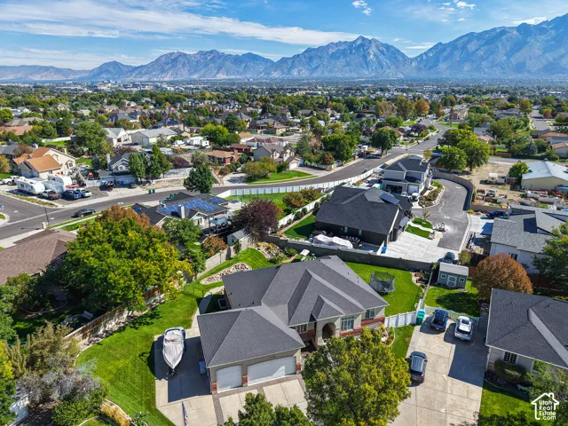 Expansive suburban setting with mature trees and mountain scenery