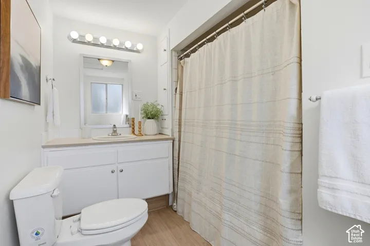 Vanity with white cabinetry, light-toned countertop, and undermount sink