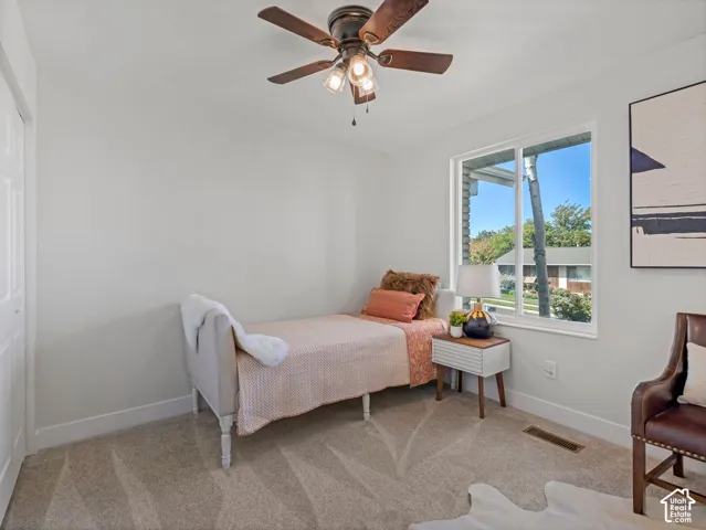 Carpeted flooring, white walls, and a window with a white frame