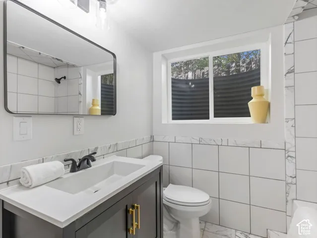 Modern vanity with a white countertop and gold-finish hardware