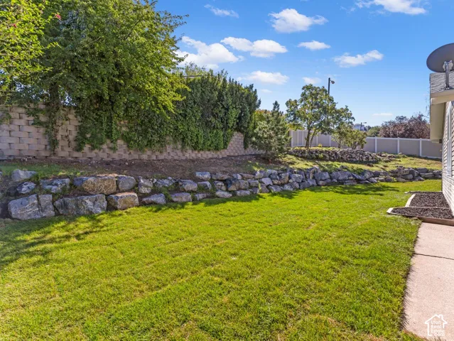 Expansive lawn area with a concrete paver walkway