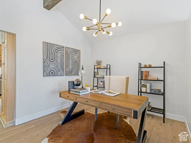 Vaulted ceiling featuring a decorative exposed beam and a modern sputnik chandelier