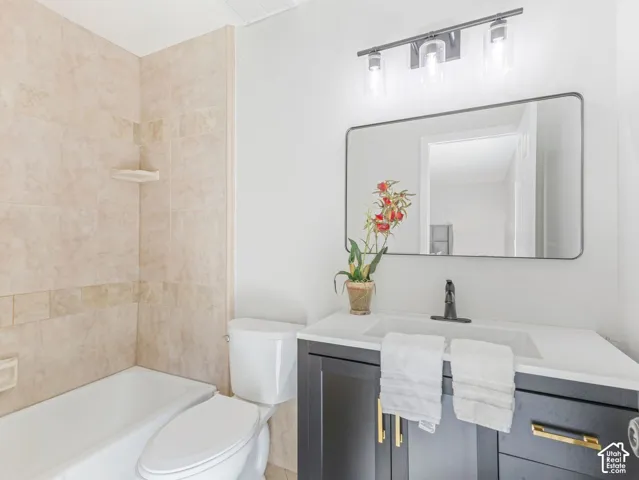 White tub with neutral-toned tiled surround