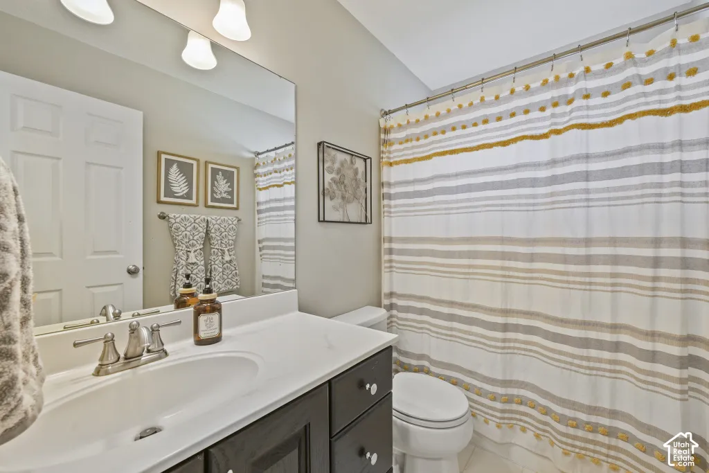 Vanity with integrated sink, brushed nickel faucet, and dark wood-finish cabinetry