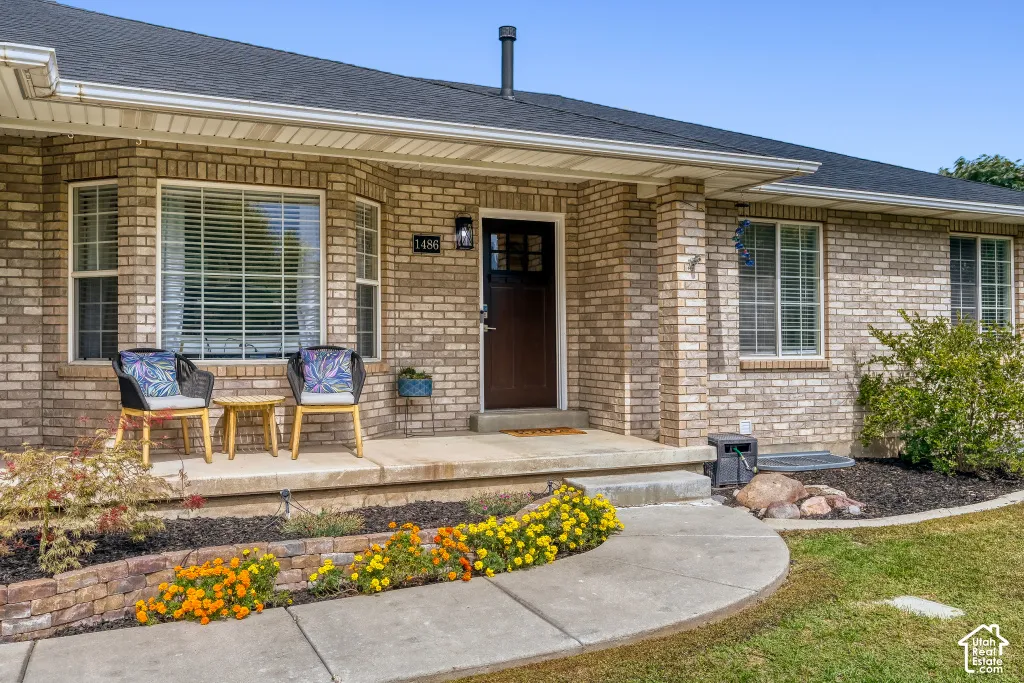 Brick exterior with a dark shingle roof and white gutters