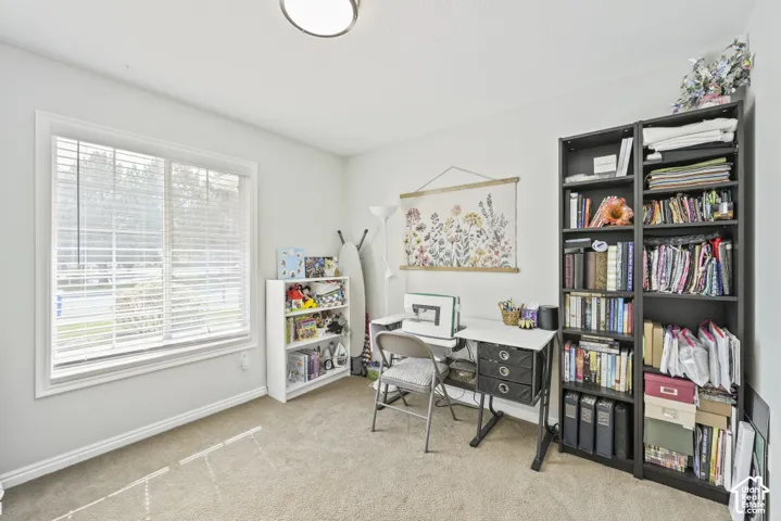 Carpeted room with a ceiling-mounted light fixture, a window with blinds, and white painted walls