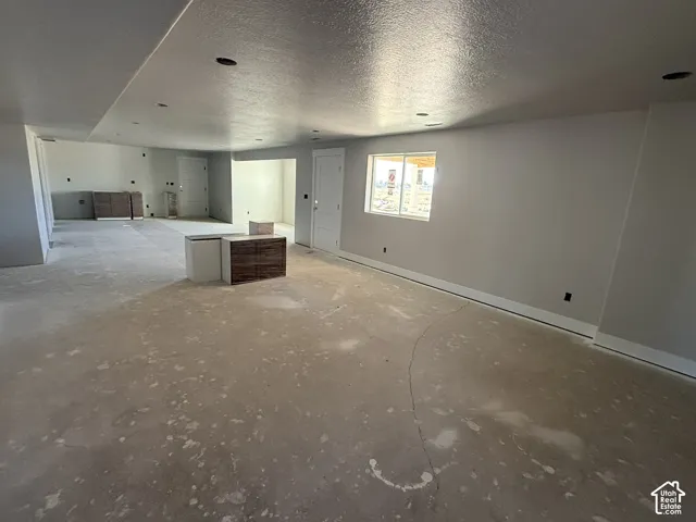 Open-concept interior space featuring recessed lighting, multi-panel doors, and built-in cabinetry with wood-finish doors