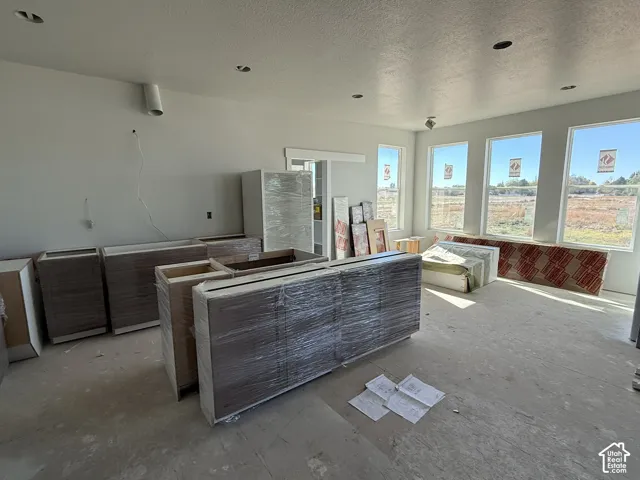 Modern kitchen featuring flat-panel cabinetry, recessed lighting, and large windows with natural illumination