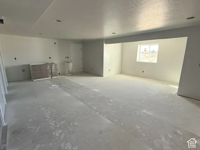 Expansive interior area featuring recessed lighting, a neutral wall finish, and built-in cabinetry