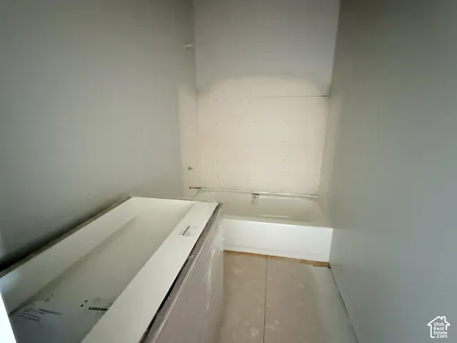 Standard bathtub with white surround and integrated cabinetry vanity