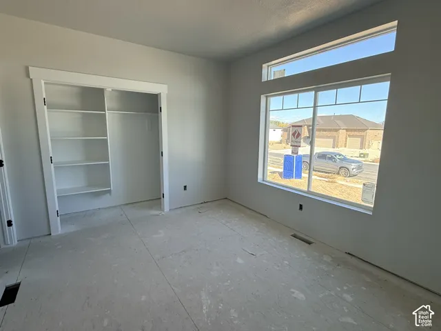Room featuring a window with a transom, built-in shelving, and white trim molding