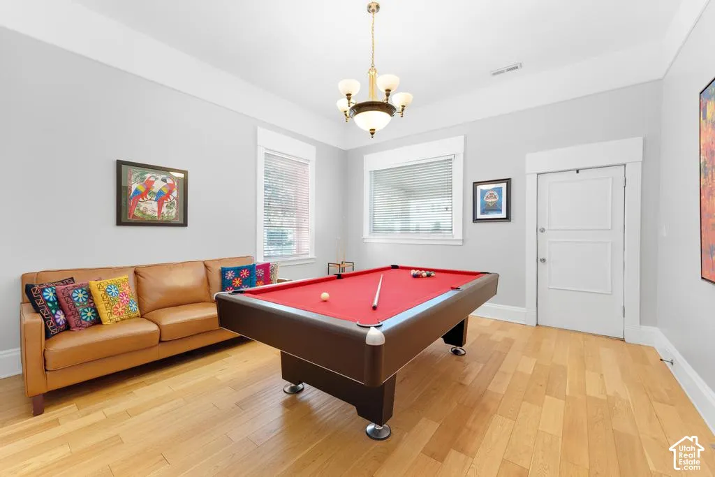 Light wood-finish flooring, white trim, and light gray walls