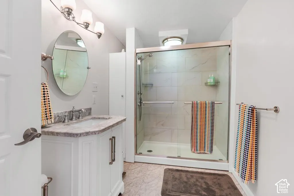 White vanity with a stone countertop and undermount sink