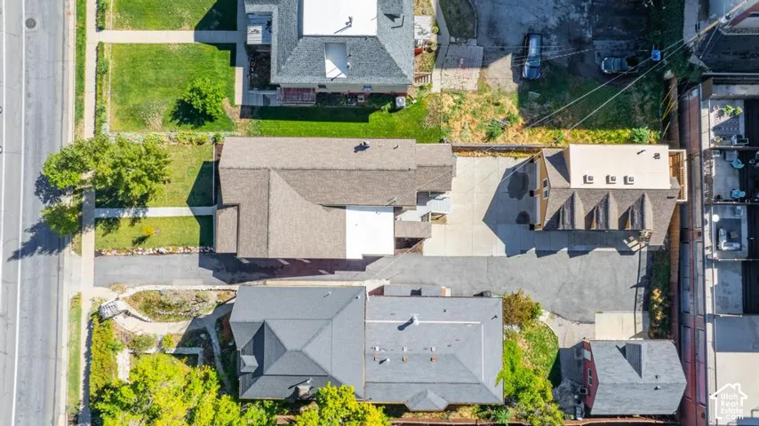 Property featuring multiple structures, paved driveways, and green spaces