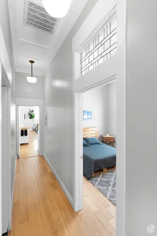 Hardwood flooring, painted walls, transom window, and ceiling-mounted lighting fixtures