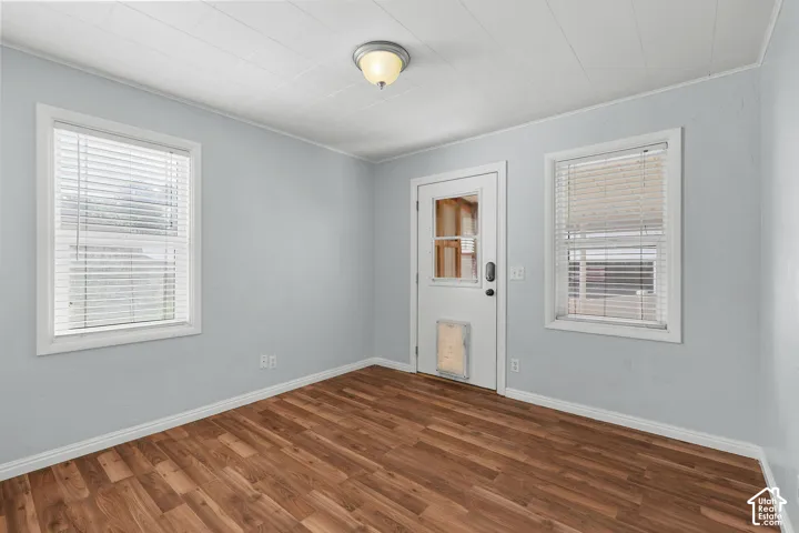 Wood-finish flooring with light-colored wall paint, white trim, and a white ceiling
