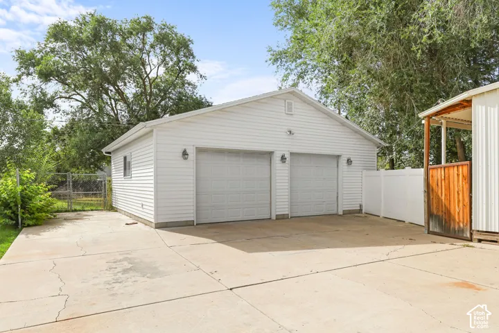 Detached two-car garage with white vinyl siding