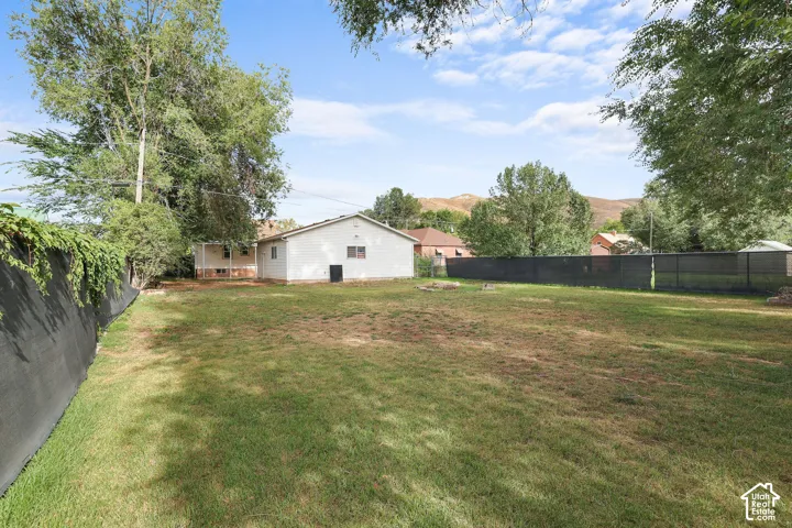 Expansive green space with a privacy fence