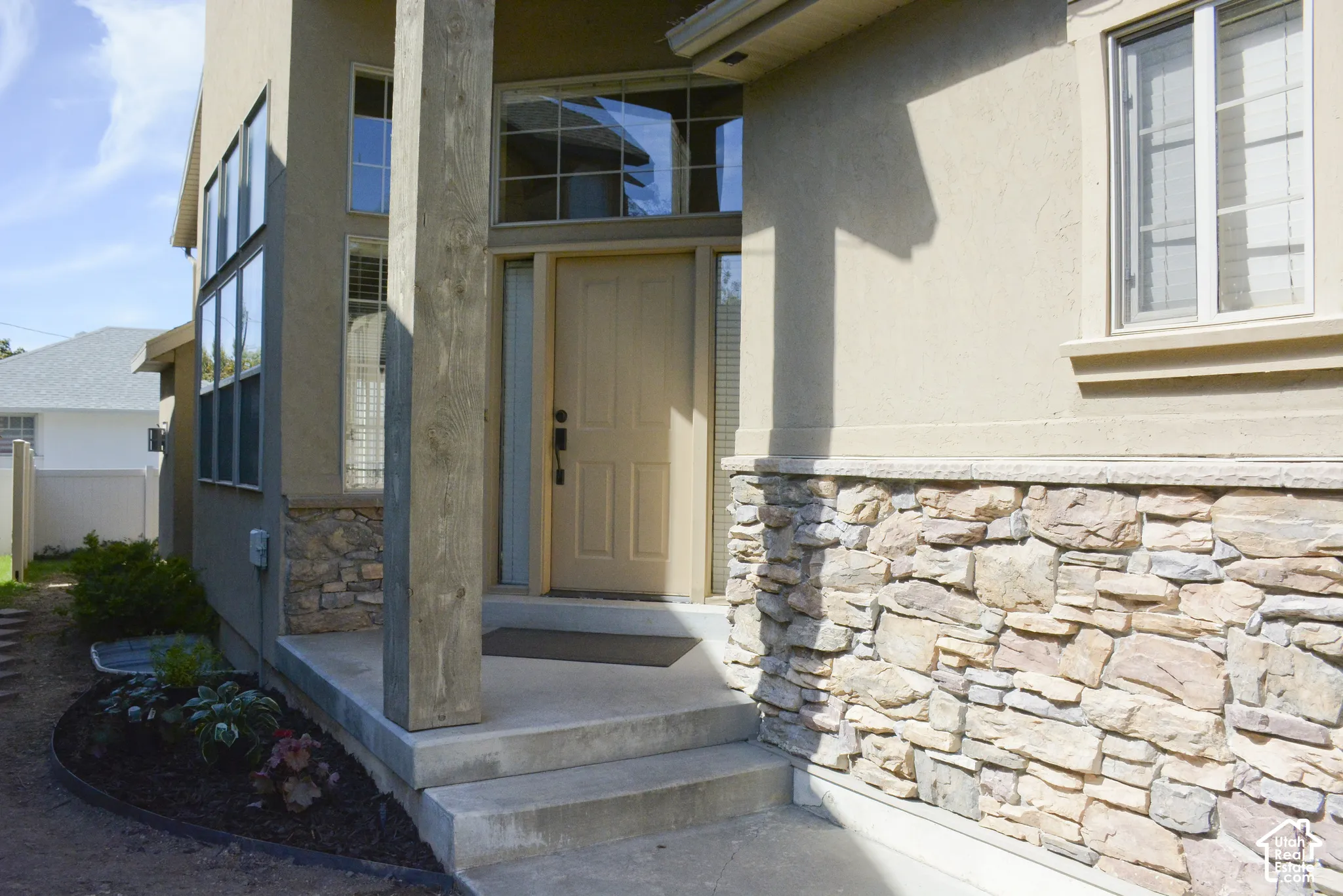 Stucco exterior with stone veneer accents