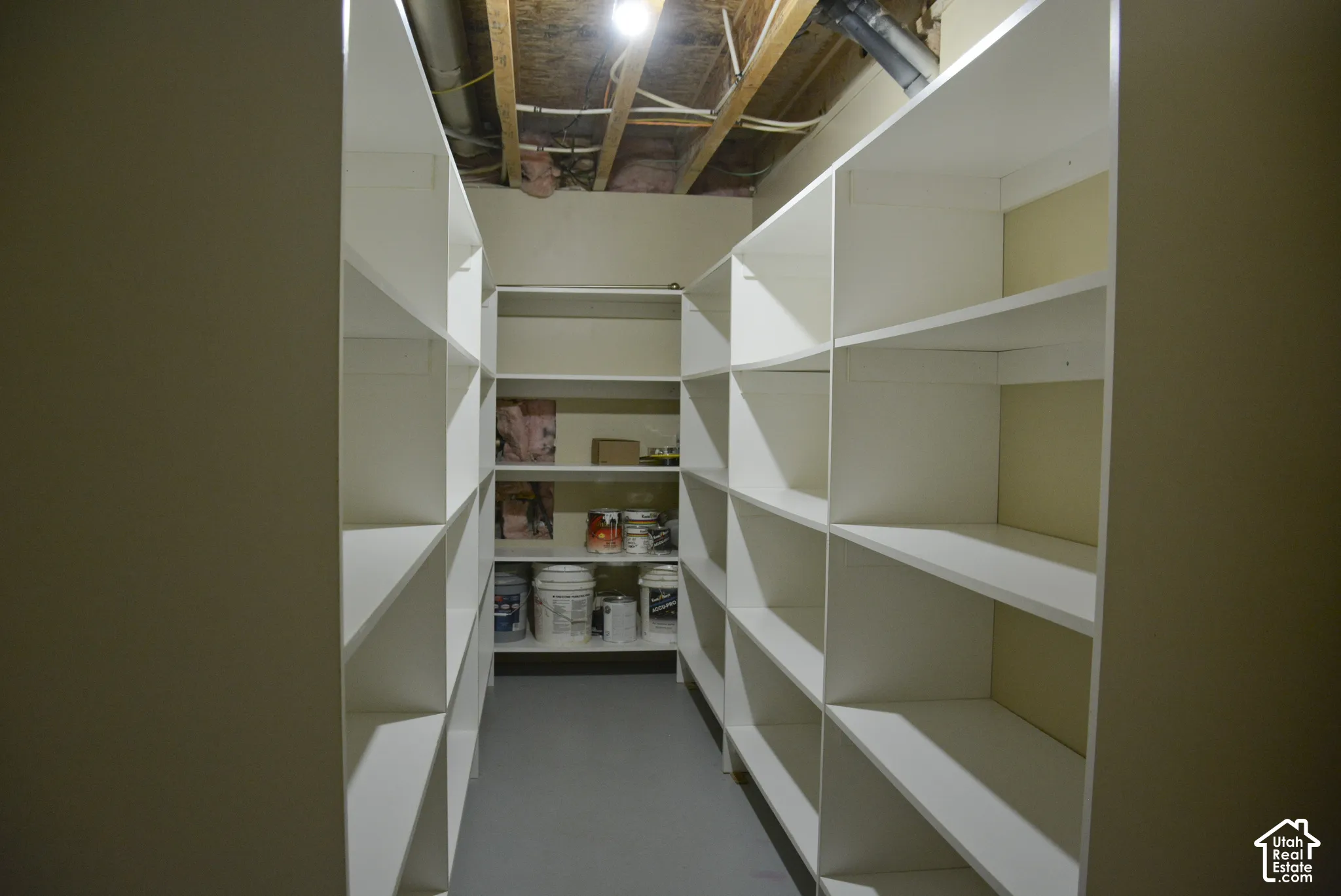 Built-in white shelving providing extensive storage