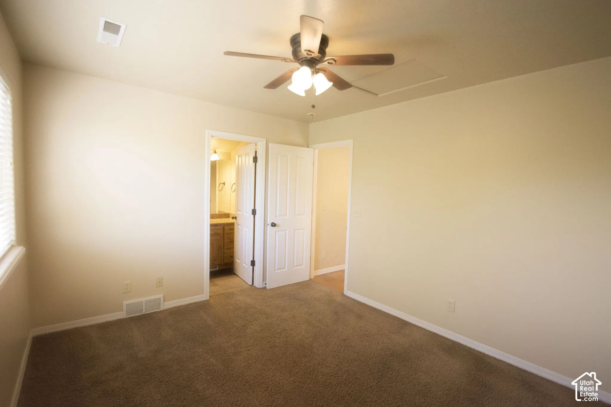 Carpeted flooring, ceiling fan with integrated lighting, and a window with blinds