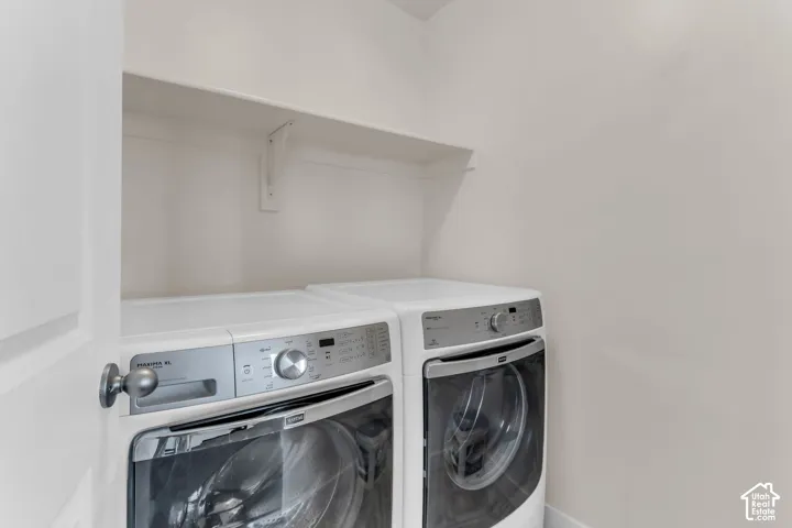 Laundry area with a built-in white shelf and white walls