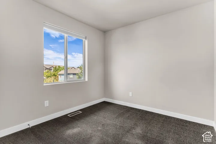 Neutral wall paint, plush carpeting, and a dual-pane window