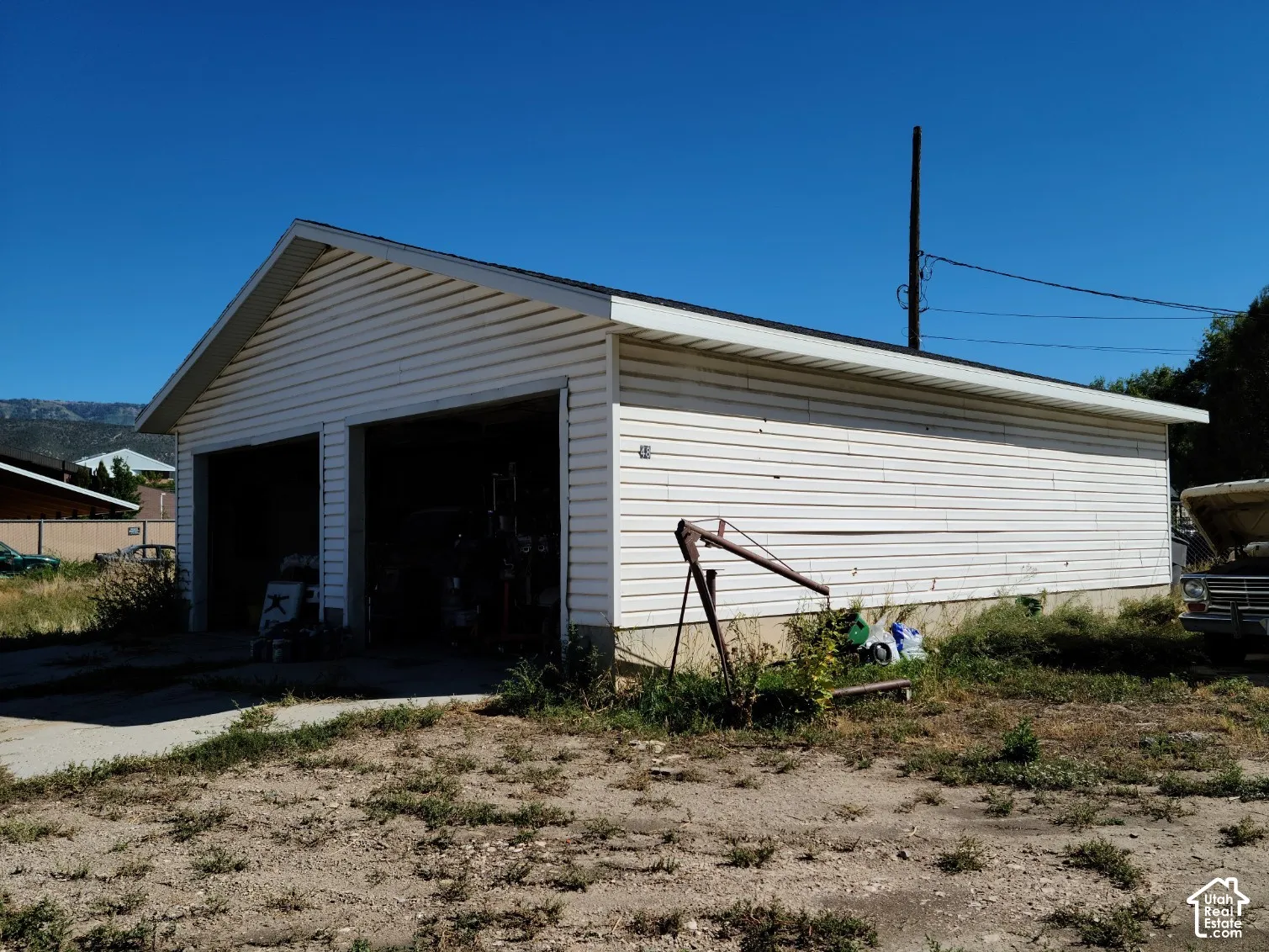 Two-car garage with vinyl siding and an asphalt shingle roof
