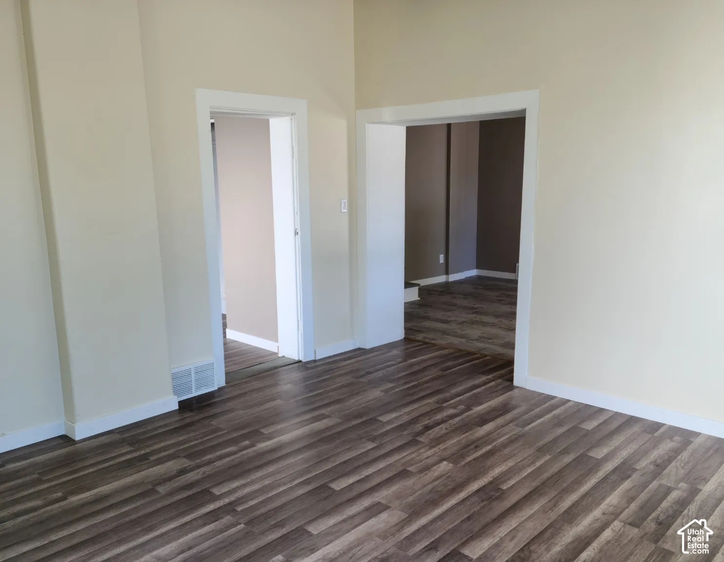Wood-finish flooring throughout, complemented by light-toned walls and white trim