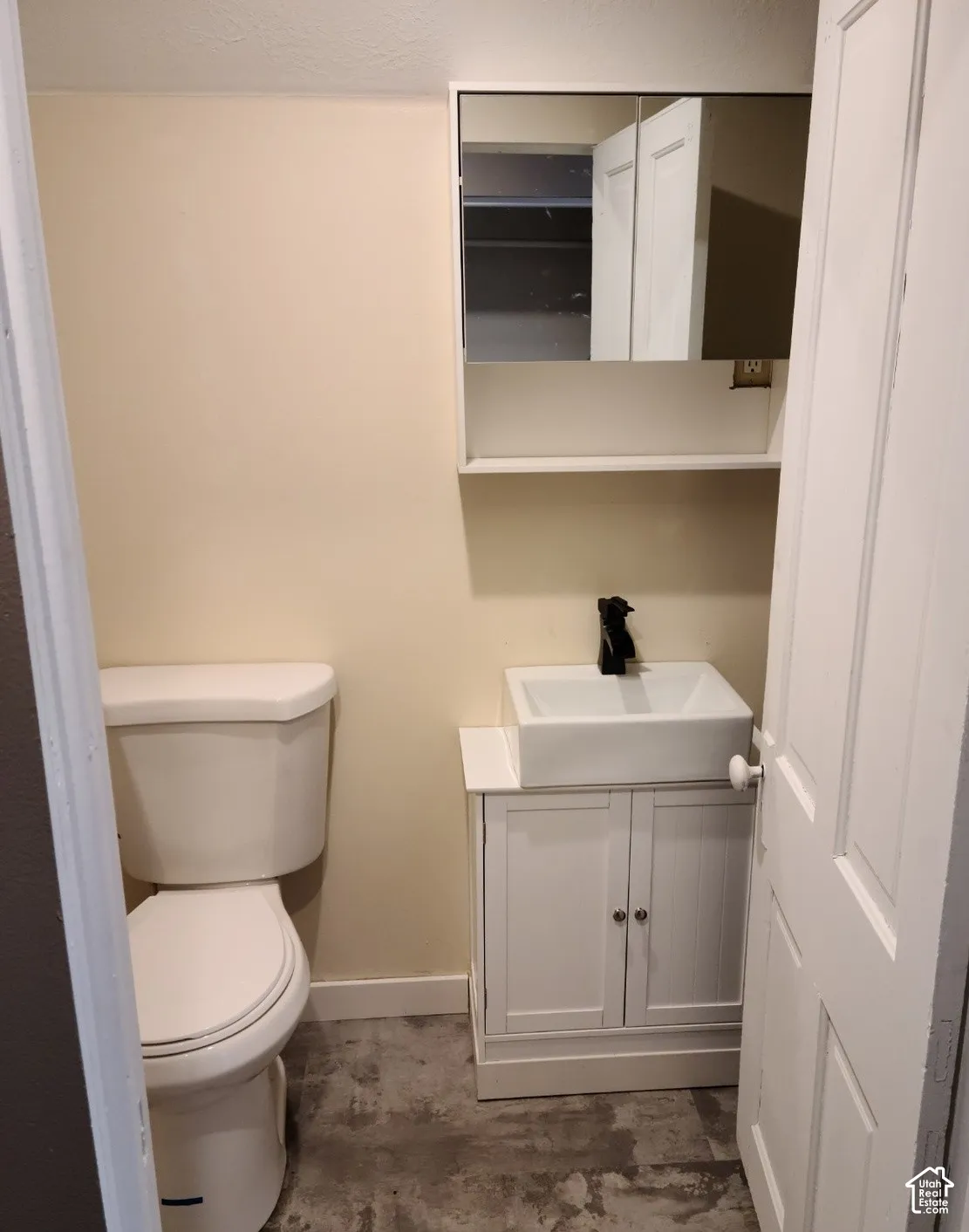 Vanity with a vessel sink, dark-finish faucet, and integrated storage