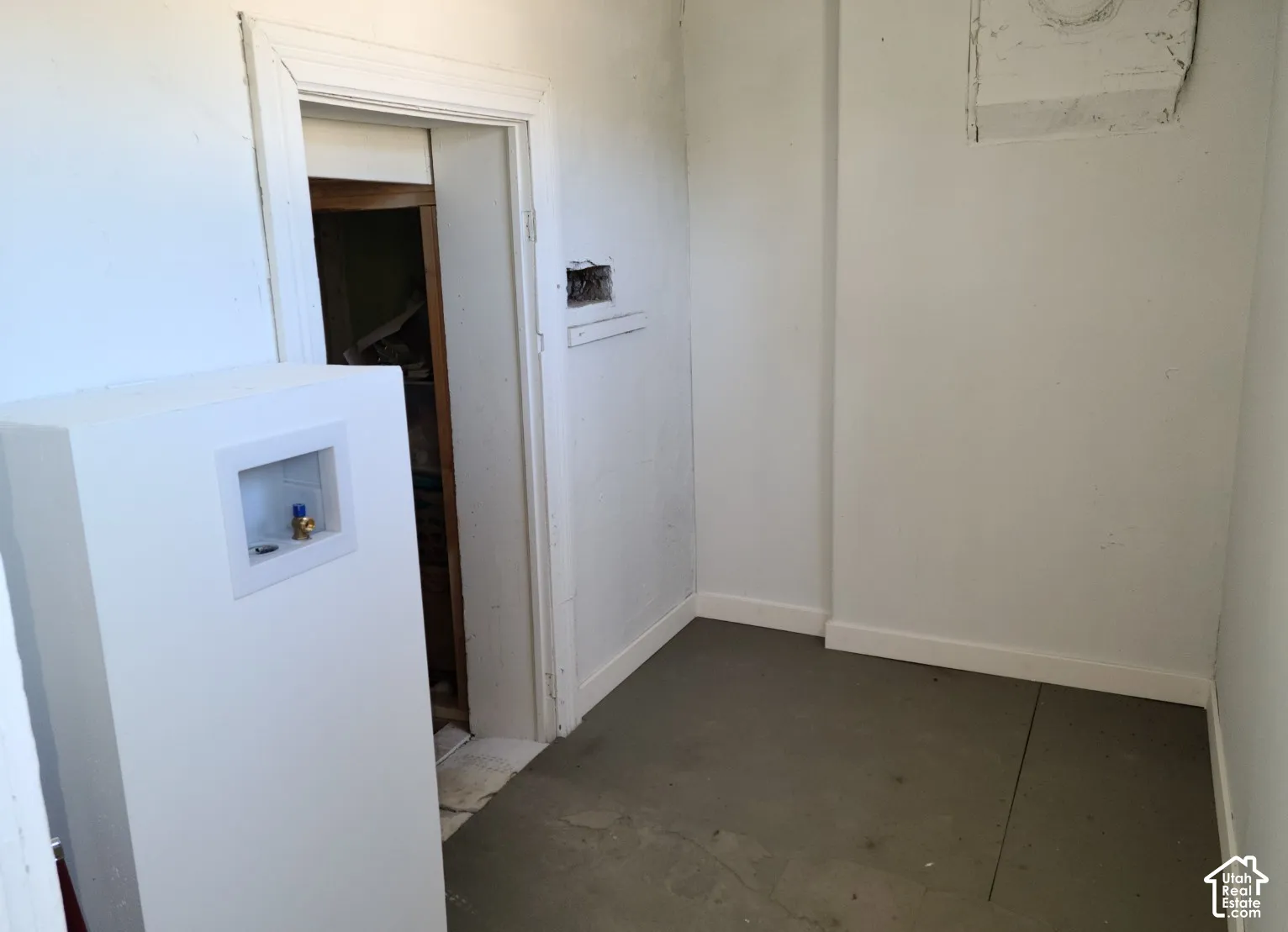 Utility area featuring a laundry hook-up box and a storage alcove