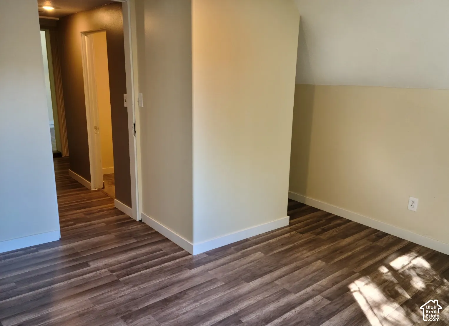 Wood-finish flooring throughout, complemented by white trim and a neutral color palette