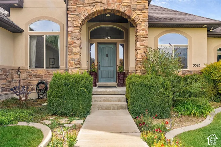 Stone archway entry with a paneled front door