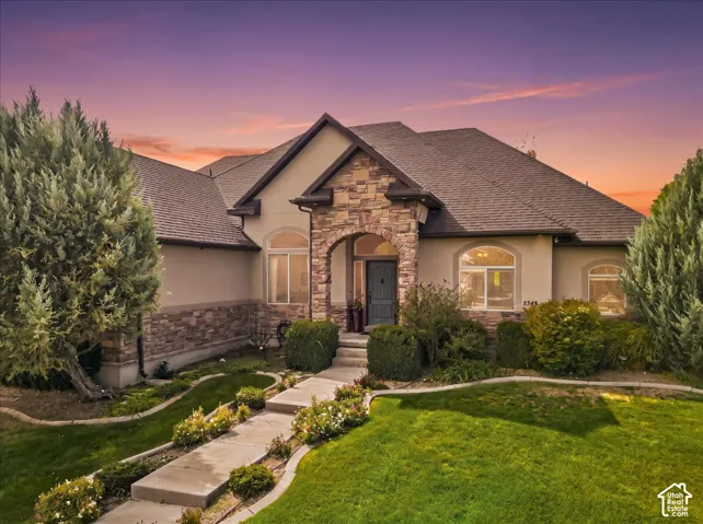 Stone and stucco exterior with an arched entry