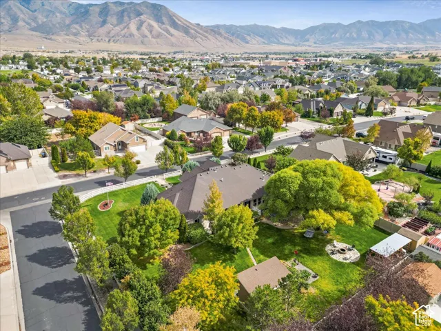 Expansive property featuring a large landscaped yard, mature trees, and a fire pit area