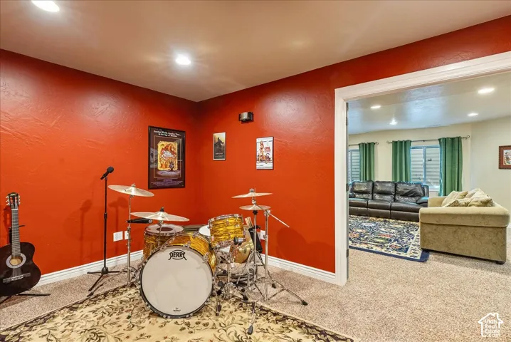 Carpeted room with recessed lighting and a wide doorway