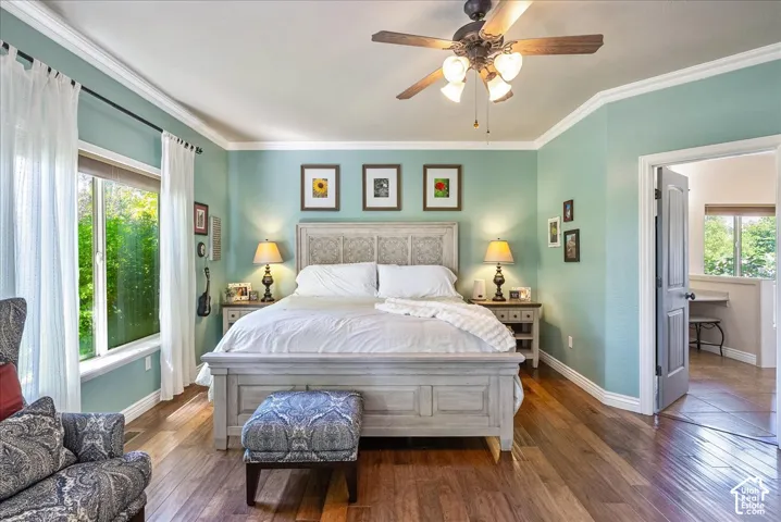 Hardwood-finish flooring, recessed window, ceiling fan, crown molding, and a solid core door
