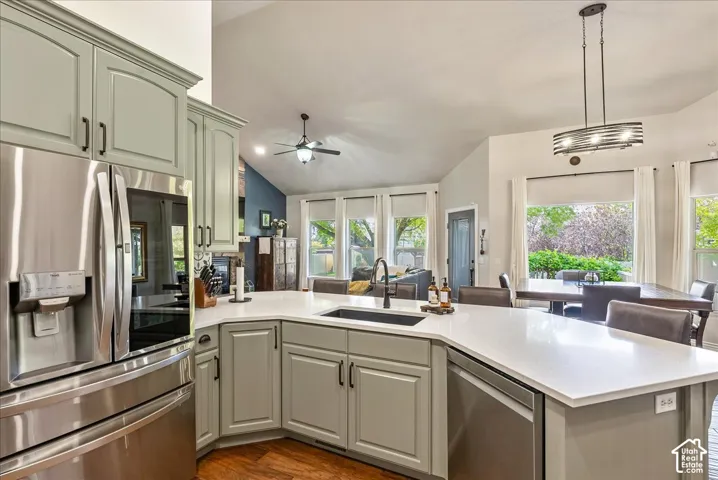 Kitchen featuring light-toned cabinetry, stainless steel appliances, a white countertop, and a built-in sink with a matte black faucet