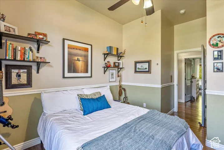 Recessed lighting, ceiling fan, wood-finish flooring, built-in shelving, two-tone wall treatment