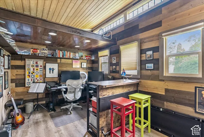 Wood-paneled walls and ceiling, built-in shelving, clerestory windows, and recessed lighting