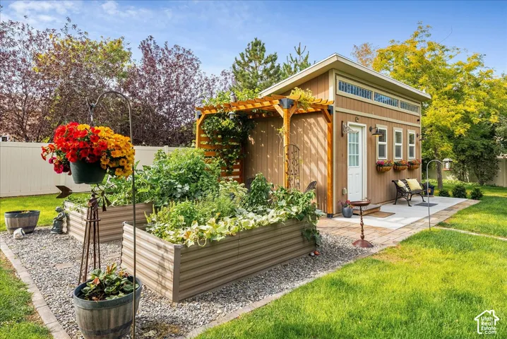 Detached shed with wood-finish siding, a pergola, and clerestory windows