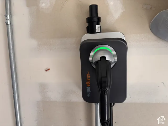 Wall-mounted electric vehicle charging station with integrated plug and cord