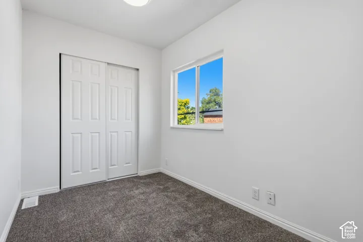 Bright interior space with clean white walls and gray carpeting