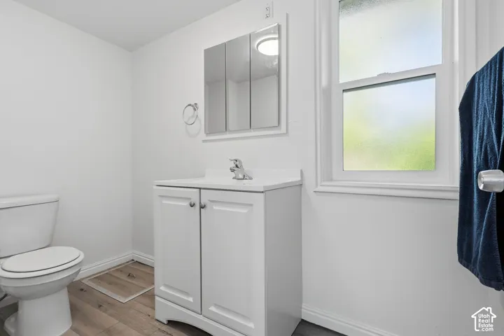 White vanity with a single basin, chrome faucet, and white countertop