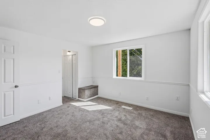 Recessed lighting, white panel doors, and two large windows