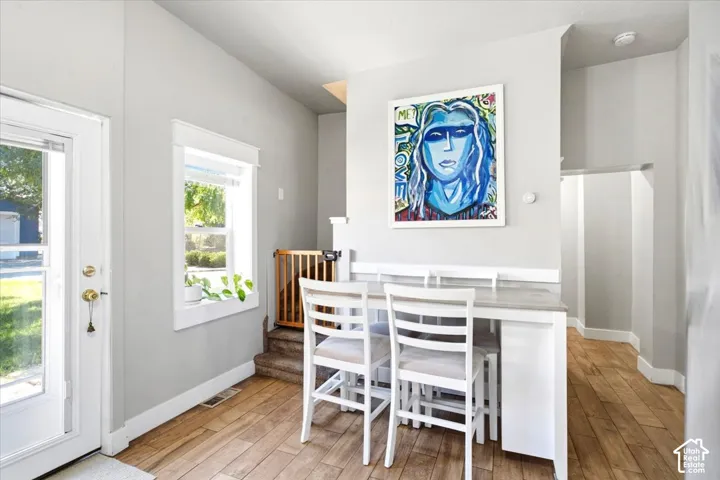 Wood-finish flooring, white trim, and light gray walls