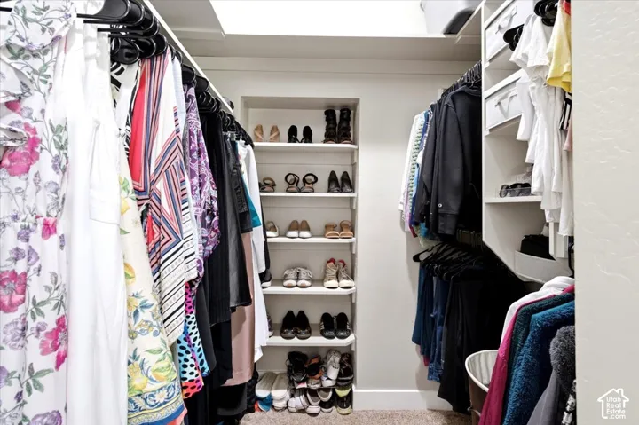 Custom closet system featuring built-in shelving, hanging rods, and recessed display niches